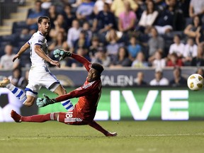 FILE - In this Saturday, Sept. 15, 2018, file photo, Montreal Impact's Alejandro Silva, left, scores a goal past Philadelphia Union goalkeeper Andre Blake in the first half of an MLS soccer match in Chester, Pa. The North is making noise in the East. And no, it's not Toronto FC. The Impact are unexpectedly in the playoff picture after a two-month climb up the standings.