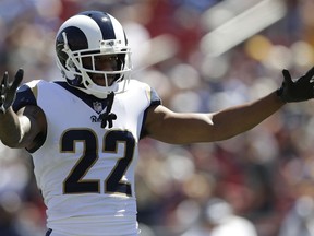 FILE - In this Sunday, Sept. 16, 2018, file photo, Los Angeles Rams cornerback Marcus Peters cheers during the first half of an NFL football game against the Arizona Cardinals in Los Angeles. The Chargers and the Rams  will meet on the Coliseum field Sunday for the first time since the two franchises' relocations to Los Angeles.AP Photo/Marcio Jose Sanchez, File)