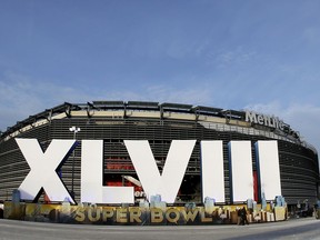 FILE - In this Feb. 1, 2014, file photo, a sign for NFL football's Super Bowl XLVIII stands in front of MetLife Stadium in East Rutherford, N.J. Lawyers for the National Football League argued before New Jersey's Supreme Court on Thursday, Sept. 27, 2018, against claims that their ticketing policies for the 2014 Super Bowl at MetLife Stadium violated state consumer fraud laws.  A New Jersey man sued after he said he had to pay a substantially higher price on the secondary market because the NFL made only 1 percent of the tickets available in a lottery.