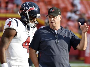 FILE - In this Aug. 9, 2018, file photo, Houston Texans quarterback Deshaun Watson (4) listens to head coach Bill O'Brien before an NFL preseason football game against the Kansas City Chiefs in Kansas City, Mo. The Texans fired back at an East Texas school superintendent who wrote: "You can't count on a black quarterback," in the comment section of an online news article where he was criticizing Watson. O 'Brien called the comments "outdated, inaccurate, ignorant and idiotic." Watson said he didn't waste time worrying about the post.