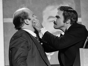 FILE - In this Dec. 2, 1977 file photo, actor Burt Reynolds, right, pinches the cheeks of comedian Dom Deluise during a roast of Reynolds in Atlanta. Reynolds, who starred in films including "Deliverance," "Boogie Nights," and the "Smokey and the Bandit" films, died at age 82, according to his agent. DeLuise died on May 4, 2009 at age 75.