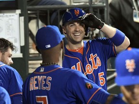 New York Mets' David Wright (5) smiles as he talks with Jose Reyes during the fifth inning of a baseball game against the Miami Marlins on Friday, Sept. 28, 2018 in New York.
