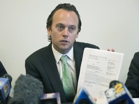 Attorney Jordan Merson holds a copy of an amended complaint he filed on behalf of Alexandra Waterbury as he speaks to reporters during a news conference, Tuesday, Sept. 18, 2018, in New York. Merson represents Waterbury, who filed a lawsuit in NY State Supreme Court against her ex-boyfriend, Chase Finlay, and the New York City Ballet, where he had been a principal dancer, after he inappropriately shared nude photos and videos of her.
