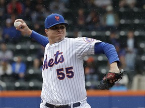 New York Mets pitcher Corey Oswalt works in the first inning of a baseball game against the Philadelphia Phillies, Sunday, Sept. 9, 2018, in New York.