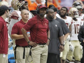 Florida State head coach Willie Taggart looks at the scoreboard late in the fourth quarter of an NCAA college football game against Syracuse in Syracuse, N.Y., Saturday, Sept. 15, 2018. Syracuse won 30-7.