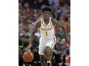 FILE - In this March 4, 2017, file photo, Texas guard Andrew Jones dribbles the ball during the second half of an NCAA college basketball game against Baylor, in Austin, Texas. Jones, who is battling leukemia, is practicing with the Longhorns but is still held out of some drills as he continues to regain strength, coach Shaka Smart said Monday, Sept. 24, 2018.