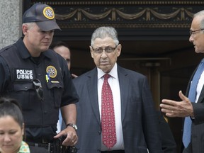 FILE - In this July 27, 2018 file photo, former New York Assembly Speaker Sheldon Silver, center, leaves federal court in New York after his sentencing. Federal appeals court judge Peter Hall said Tuesday, Sept. 25 that Silver might not have to report to prison until a judicial panel decides if he can remain free on bail while he appeals.  Silver was sentenced to seven years in prison after he was convicted earlier this year of accepting nearly $4 million in return for legislative favors.