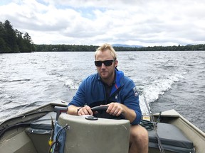 In this Sept. 1, 2018, photo, Andrew Weibrecht, aka "War Horse," pilots his boat on Lake Placid in the Adirondack Mountains of New York. The two-time Olympic medalist in downhill skiing retired in May at age 32 to spend more time with his young family and learn the family business. His parents operate the Mirror Lake Inn, one of the signature resorts in the East.
