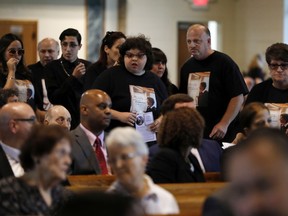 Mourners arrive for the funeral for Evelyn Rodriguez, at Saint Anne's Roman Catholic Church, in Brentwood, N.Y., Friday, Sept. 21, 2018. Rodriguez, 50, is a mother recognized by President Donald Trump for turning grief over her daughter's suspected gang killing into a crusade against MS-13. She was struck and killed by an SUV on Sept. 14 after a heated confrontation with the driver over the placement of a memorial to her slain daughter, Kayla Cuevas.