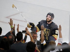 FILE - In this Monday, May 28, 2018, file photo, Vegas Golden Knights defenseman Shea Theodore gives his stick to fans after the Knights defeated the Washington Capitals 6-4 in Game 1 of the NHL hockey Stanley Cup Finals in Las Vegas. Theodore ended his holdout late Monday, Sept. 24, 2018, agreeing to a seven-year contract with the Vegas Golden Knights.