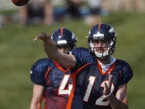 FILE - In this Tuesday, Aug. 7, 2018, file photo, Denver Broncos quarterback Paxton Lynch takes part in drills at NFL football training camp in Englewood, Colo. John Elway cut ties with his biggest draft bust Sunday, Sept. 2, 2018, when he waived quarterback Paxton Lynch less than 24 hours after including him on the Denver Broncos' 53-man roster.