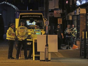 Emergency services personnel stage outside Prezzo restaurant, Sunday, Sept. 16, 2018, in Salisbury, United Kingdom, where police have closed streets as a "precautionary measure" after two people were taken ill from the restaurant, amid heightened tensions after the Novichok poisonings earlier in the year.