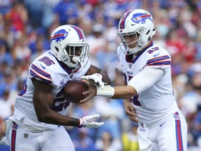 Buffalo Bills quarterback Josh Allen, right, hands off to LeSean McCoy during the first half an NFL football game against the Los Angeles Chargers, Sunday, Sept. 16, 2018, in Orchard Park, N.Y.