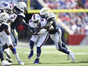 Los Angeles Chargers defense brings down Buffalo Bills' LeSean McCoy, center, during the first half of an NFL football game, Sunday, Sept. 16, 2018, in Orchard Park, N.Y.