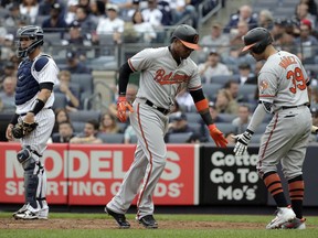 Baltimore Orioles' Tim Beckham, center, celebrates his solo home run with Renato Nunez, right, during the second inning of a baseball game against the New York Yankees at Yankee Stadium, Sunday, Sept. 23, 2018, in New York.