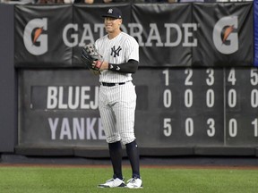 New York Yankees right fielder Aaron Judge smiles after coming into the baseball game in the eighth inning against the Toronto Blue Jays Friday, Sept.14, 2018, at Yankee Stadium in New York.
