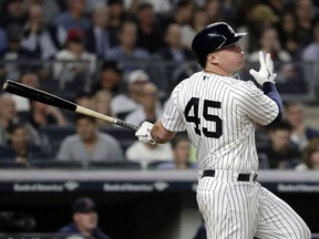 New York Yankees' Luke Voit watches his two-run home run off Boston Red Sox starting pitcher Eduardo Rodriguez during the second inning of a baseball game Thursday, Sept. 20, 2018, in New York.