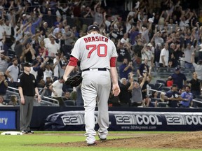 Boston Red Sox relief pitcher Ryan Brasier reacts after giving up a three-run home run to New York Yankees' Neil Walker during the seventh inning of a baseball game Tuesday, Sept. 18, 2018, in New York.