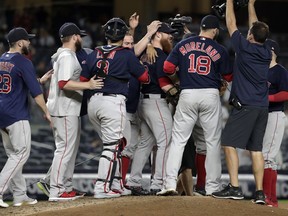 Boston Red Sox players surround relief pitcher Craig Kimbrel, center, after they defeated the New York Yankees 11-6 during a baseball game Thursday, Sept. 20, 2018, in New York. With the win, the Red Sox clinched the American League East title.