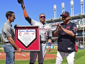 Detroit Tigers' Victor Martinez, center, waves to fans acknowledging his retirement during a pregame ceremony before a baseball game between the Cleveland Indians and Detroit Tigers, Saturday, Sept.15, 2018, in Cleveland.