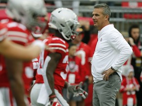 Ohio State head coach Urban Meyer watches his team warm up before an NCAA college football game against Tulane Saturday, Sept. 22, 2018, in Columbus, Ohio. Meyer is returning to his coaching duties after a three-game suspension.