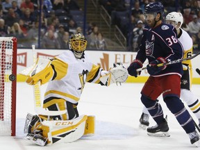 Pittsburgh Penguins' Casey DeSmith, left, makes a save against Columbus Blue Jackets' Boone Jenner during the second period of a preseason NHL hockey game Friday, Sept. 28, 2018, in Columbus, Ohio.