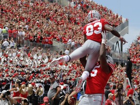 Ohio State receiver Terry McLaurin is lifted in celebration by teammate Jaylen Harris after scoring a touchdown against Oregon State during the first half of an NCAA college football game Saturday, Sept. 1, 2018, in Columbus, Ohio.