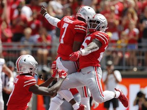 Ohio State running back Mike Weber, right, and quarterback Dwayne Haskins celebrate Weber's touchdown against Oregon State during the first half of an NCAA college football game Saturday, Sept. 1, 2018, in Columbus, Ohio.