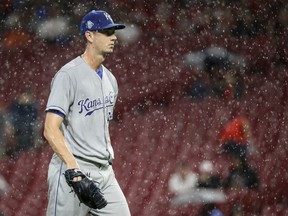 Kansas City Royals starting pitcher Eric Skoglund walks back to the dugout during a rain delay in the third inning of the team's baseball game against the Cincinnati Reds, Tuesday, Sept. 25, 2018, in Cincinnati.