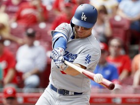 Los Angeles Dodgers left fielder Joc Pederson hits a double off Cincinnati Reds starting pitcher Anthony DeSclafani in the fifth inning of a baseball game, Wednesday, Sept. 12, 2018, in Cincinnati.