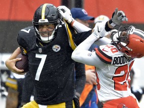 Pittsburgh Steelers quarterback Ben Roethlisberger (7) runs for a first down under pressure from Cleveland Browns cornerback Briean Boddy-Calhoun (20) during the first half of an NFL football game, Sunday, Sept. 9, 2018, in Cleveland.