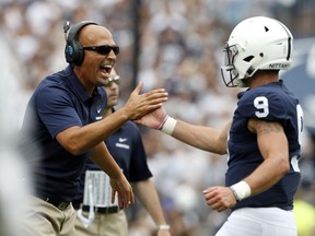 Penn State head coach James Franklin, left, congratulates quarterback Trace McSorley (9) after scoring against Appalachian State during the first half of an NCAA college football game in State College, Pa., Saturday, Sept. 1, 2018.
