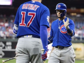Chicago Cubs' Javier Baez, right, celebrates his run with Kris Bryant, left, on a double by Ben Zobrist during the first inning of a baseball game against the Philadelphia Phillies, Saturday, Sept. 1, 2018, in Philadelphia.