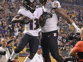 Baltimore Ravens wide receiver John Brown (13) celebrates with Maxx Williams after a 33 yard touchdown reception in the first half of an NFL football game against the Pittsburgh Steelers in Pittsburgh, Sunday, Sept. 30, 2018.