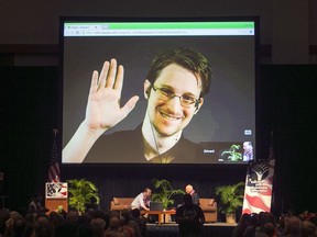 FILE - In this Feb. 14, 2015, file photo, Edward Snowden appears on a live video feed broadcast from Moscow at an event sponsored by ACLU Hawaii in Honolulu. Europe's human rights court is about to publish what could be a landmark ruling on the legality of mass surveillance. The case brought by civil liberties, human rights and journalism groups and campaigners challenges British surveillance and intelligence-sharing practices revealed by American whistleblower Edward Snowden.