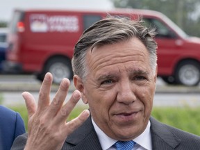 Coalition Avenir Quebec Leader Francois Legault responds to questions during a news conference next to a busy highway in St-Hubert, Que., Tuesday, Sept. 18, 2018.