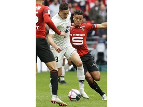 PSG's Julian Draxler passes Rennes' Rame Bensebaini, left, and Rennes' Hatem Ben Afra, right, during their French League One soccer match between Rennes and Paris-Saint-Germain at Roazhon Park stadium in Rennes, western France, Sunday, Sept. 23, 2018.