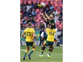 South Africa's Willie le Roux, back right and Australia's Israel Folau, front right, do battle for the ball during their rugby test match in Port Elizabeth, South Africa, Saturday, Sept. 29, 2018. (AP Photo)