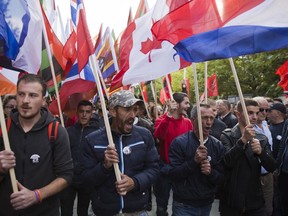 Thousands of supporters of Kosovo's opposition Self-Determination shouting slogans and waving flags of the world countries march through toward Skanderbeg Square on Saturday, Sept. 29, 2018, in Kosovo capital Pristina. Thousands of people in Kosovo are protesting their president's willingness to include a possible territory swap with Serbia in the ongoing negotiations to normalize relations between the two countries.