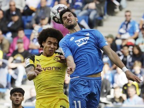 Hoffenheim's Florian Grillitsch, right, and Dortmund's Axel Witsel challenge for the ball during a German Bundesliga soccer match between TSG 1899 Hoffenheim and Borussia Dortmund in Sinsheim, Germany, Saturday, Sept. 22, 2018.