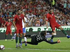 Portugal's Bernardo Silva, right tries to score past Italy goalkeeper Gianluigi Donnarumma during the UEFA Nations League soccer match between Portugal and Italy at the Luz stadium in Lisbon, Monday, Sept. 10, 2018.