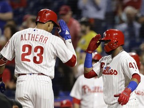 Philadelphia Phillies' Aaron Altherr, left, and Carlos Santana celebrate after Altherr's two-run home off Miami Marlins starting pitcher Wei-Yin Chen during the second inning of a baseball game, Friday, Sept. 14, 2018, in Philadelphia.