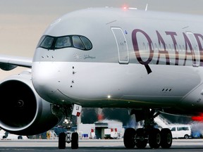 FILE - In this Jan. 15, 2015, file photo, a Qatar Airways jet arriving from Doha, Qatar, approaches the gate at the airport in Frankfurt, Germany. Qatar Airways said Tuesday, Sept. 18, 2018 that it suffered a loss of $69 million this year off revenue of $11.5 billion amid a boycott of Doha by four Arab nations.