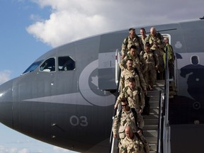 Soldiers disembark from their plane as they return home from Afghanistan at the Edmonton International Airport in Edmonton, Alta. on Friday, Oct. 11, 2013.