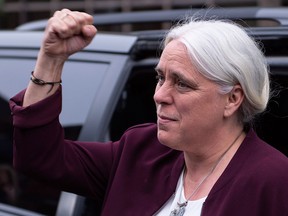 Quebec solidaire leader Manon Masse gestures to supporters as she arrives for the Quebec elections leader debate in Montreal on Sept. 20, 2018.