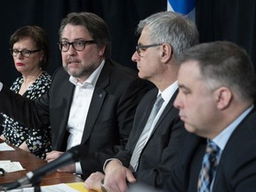 Quebec ministers Lucie Charlebois, David Heurtel, Jean-Marc Fournier and Sebastien Proulx, left to right, discuss the situation involving asylum seekers during a news conference, Monday, April 16, 2018 in Montreal.