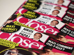 FILE - In this Friday, Sept. 14, 2012 file photo a stack of Closer magazines are displayed at the magazine's headquarter, in Montrouge, outside Paris. A French court of appeals has upheld a ruling that two directors of French celebrity magazine Closer should be fined a maximum 45,000 euros ($52,500) for breaching the privacy of Kate Middleton, when publishing topless photos of the Duchess of Cambridge back in 2012.