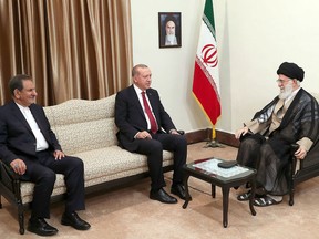 A handout picture released on September 7, 2018, by the office of the Iranian supreme leader Ayatollah Ali Khamenei (R) on September 07, 2018, shows him talking with Turkish president Recep Tayyip Erdogan (C) and Iranian vice president Eshagh Jahangir (L) during a meeting in Tehran.