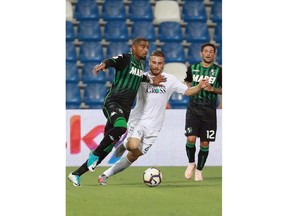 Sassuolo's Kevin Prince Boateng, left, vies for the ball with Empoli's Leonardo Capezzi during a Serie A soccer match between Sassuolo and Empoli, at Mapei stadium, in Reggio Emilia, Italy, Friday, Sept. 21, 2018.