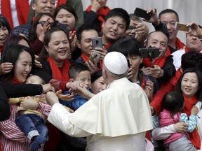 FILE - In this April 18, 2018 file photo, Pope Francis meets a group of faithful from China at the end of his weekly general audience in St. Peter's Square, at the Vatican. On Saturday, Sept. 22, 2018, the Vatican announced it had signed a "provisional agreement" with China on the appointment of bishops, a breakthrough on an issue that for decades fueled tensions between the Holy See and Beijing and thwarted efforts toward diplomatic relations.